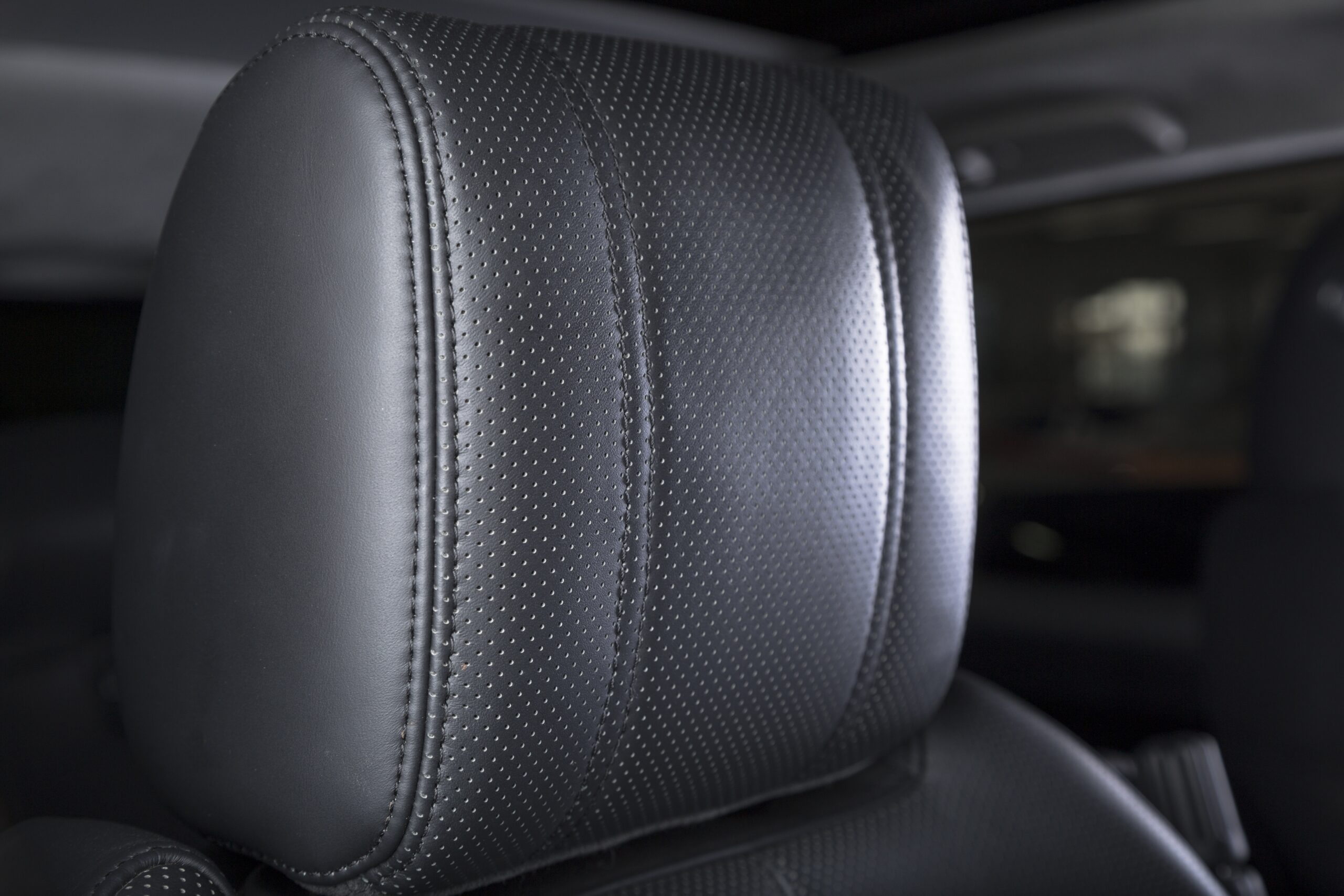 Cận cảnh ghế da đục lỗ perforated màu đen trên nội thất ô tô hiện đại